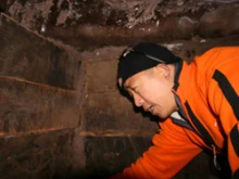 A Chinese explorer inside one of the wooden structures on Mt. Ararat. 