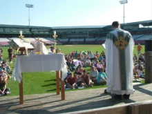 Fr. Paul Fasano celebrates Mass in the Kane County Cougars stadium.