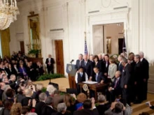 President Obama signs the health care overhaul into law. 