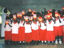 African children proudly hold up their Child's Bibles. 