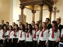 A young adult choir prepares to perform at a celebration for Archbishop Jeanbart's 