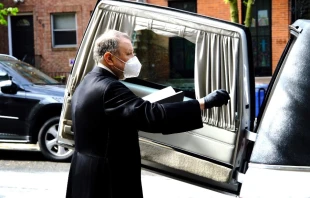 Monsignor Kieran Harrington blesses the coffin of Fr. Jorge Ortiz-Garay before its trip to Mexico.   Diocese of Brooklyn