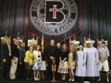 Bishop Finn poses with Benedictine students and alumni from the Diocese of Kansas City – St. Joseph / Photo 