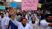 Supporters of a religious group march during a rally in support of Khalid Khan, who killed a man accused of blasphemy, in Peshawar on July 31, 2020.