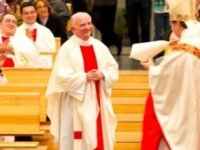 Monsignor Robert McGuckin is presented with the decree naming him prelate of honor by Bishop Anthony Fisher. 