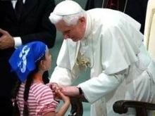 Pope Benedict greets a child at the Vatican