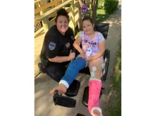 Rosie Sajevic (R) recovering from her accident with a local police officer. Photo courtesy of Teresa Sajevic.