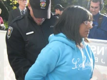 Ruth Lobo is handcuffed by the Ottawa police. 