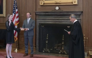 Chief Justice John G. Roberts administers the Judicial Oath to Judge Amy Coney Barrett in the Supreme Court Building. Barrett's husband Jesse holds the Bible.   Fred Schilling/Supreme Cour