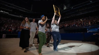 Perpetual Pilgrims from the St. Juan Diego Route process into Lucas Oil Stadium in July 2024 with an image of their patron saint.