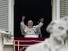 Pope Benedict prays the Angelus from the window of his study overlooking St. Peter's Square