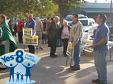 Yes on 8 supporters holding yard signs in front of St. Stanislaus