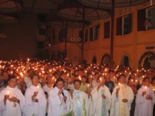 Priests and parishioners hold a candle light vigil by Lake Ba Giang