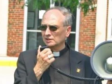 Fr. Andrew Wesley speaking at a rally against the "human rights" ordinance