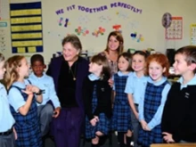 Mrs. Barbara Henkels poses for a picture with Catholic school children