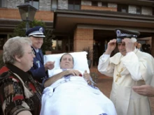 Pope Benedict accepts the hat of the terminally ill officer