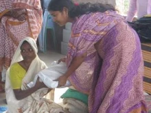 A leper receives help in India