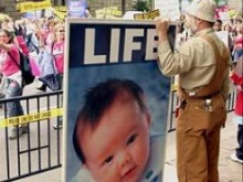 A pro-life protestor holding a protest sign