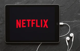 Screen on an iPad showing Netflix logo.   Kaspars Grinvalds/Shutterstock