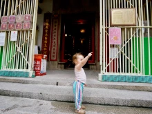 A child standing at the entrance of a house in central Hong Kong. 