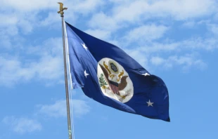 A blue flag with the official seal of the U.S. government flies over the headquarters of the Department of State in Foggy Bottom. Via Shutterstock 