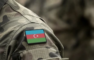 Flag of Azerbaijan on military uniform. Bumble Dee/Shutterstock