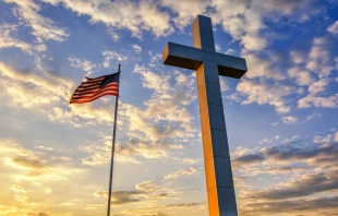 Flag and cross at sunset.   anthonyheflin/Shutterstock