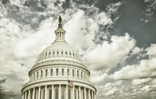 US Capitol dome with clouds.   DanThronberg/Shutterstock