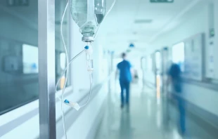 Silhouette of a doctor walking in a hurry in the hospital corridor.   Shutterstock