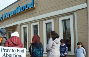 Pro-life volunteers pray outside a Planned Parenthood facility in 2017.   Linda Parton / Shutterstock. 