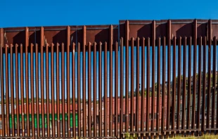 Closeup of border fence between US and Mexico in Nogales, Arizona. Via Shutterstock. 