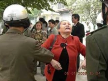 One of the protestors in Hanoi being manhandled by the police