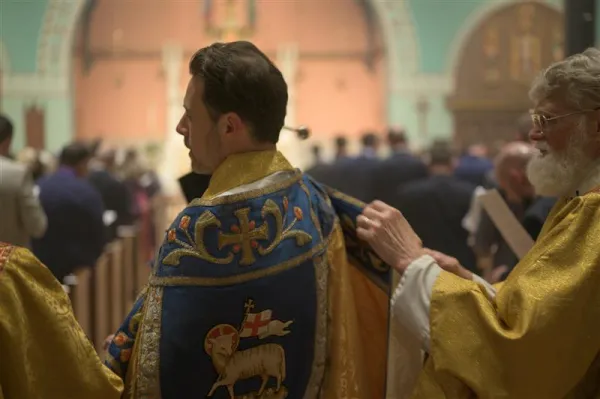 Father Albert Scharbach, pastor of Mount Calvary Catholic Church in Baltimore, blesses Mass attendees with holy water during the Easter Vigil liturgy. Just over 10 years after being founded, the Ordinariate of the Chair of Saint Peter has 11,255 faithful, 81 priests, seven seminarians, and 36 parishes and communities across the U.S. and Canada. Credit: Photo courtesy of Mount Calvary Catholic Church