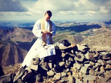 Father John Nepil of the Archdiocese of Denver celebrates Mass on top of Wetterhorn Peak in the San Juan Mountains in Colorado.