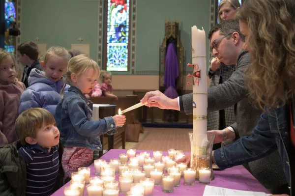 Parents help children light candles at a “Children’s Liturgy of Light” celebrated on Palm Sunday at Mount Calvary Catholic Church in Baltimore. Father Albert Scharbach, pastor of Mount Calvary, told CNA that the median age at the parish is 12. He said that “our primary focus here is to bring forward the roots of the faith with newness and vitality. That's what families are after.” Credit: Photo courtesy of Mount Calvary Catholic Church