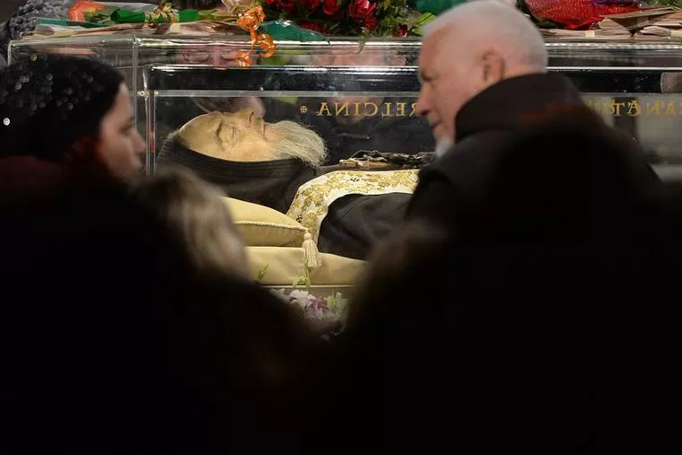 Worshippers gather to pray in front of the exhumed body of mystic-saint Padre Pio in the Catholic Church of San Lorenzo fuori le Mura (St. Lawrence Outside the Walls) in Rome on Feb. 4, 2016.