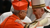 Pope Francis speaks to Archbishop William Seng Chye Goh (left) after he elevated him to cardinal during a consistory to create 20 new cardinals on Aug. 27, 2022, at St. Peter’s Basilica at the Vatican.