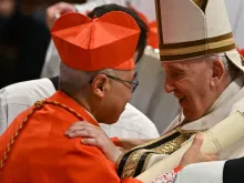 Pope Francis speaks to Archbishop William Seng Chye Goh (left) after he elevated him to cardinal during a consistory to create 20 new cardinals on Aug. 27, 2022, at St. Peter’s Basilica at the Vatican.