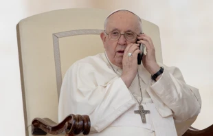 Pope Francis takes a telephone call during the May 17 General Audience. Daniel Ibáñez/EWTN News