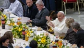 Pope Francis raises his glass at the start of a lunch with poor and economically disadvantaged people in the Vatican's Paul VI Hall on Nov. 19, 2023.