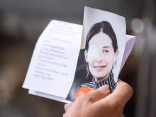 An attendee holds a photo of Chiara Corbella Petrillo at the closing of the diocesan phase of the investigation into her life and virtues in Rome on Friday, June 21, 2024.