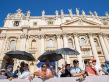 Pilgrims shield themselves from the sun at Pope Francis' general audience in St. Peter's Square at the Vatican, Wednesday, June 26, 2024.