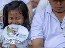 A young Catholic attends the papal Mass at Gelora Bung Karno Stadium in Jakarta on Thursday, Sept. 5, 2024.