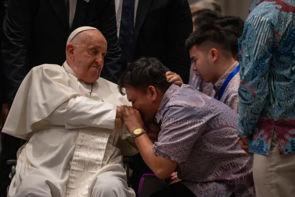 A visitor greets Pope Francis at the Indonesian Bishops’ Conference headquarters in Jakarta on Thursday, Sept. 5, 2024. Credit: Daniel Ibáñez/CNA