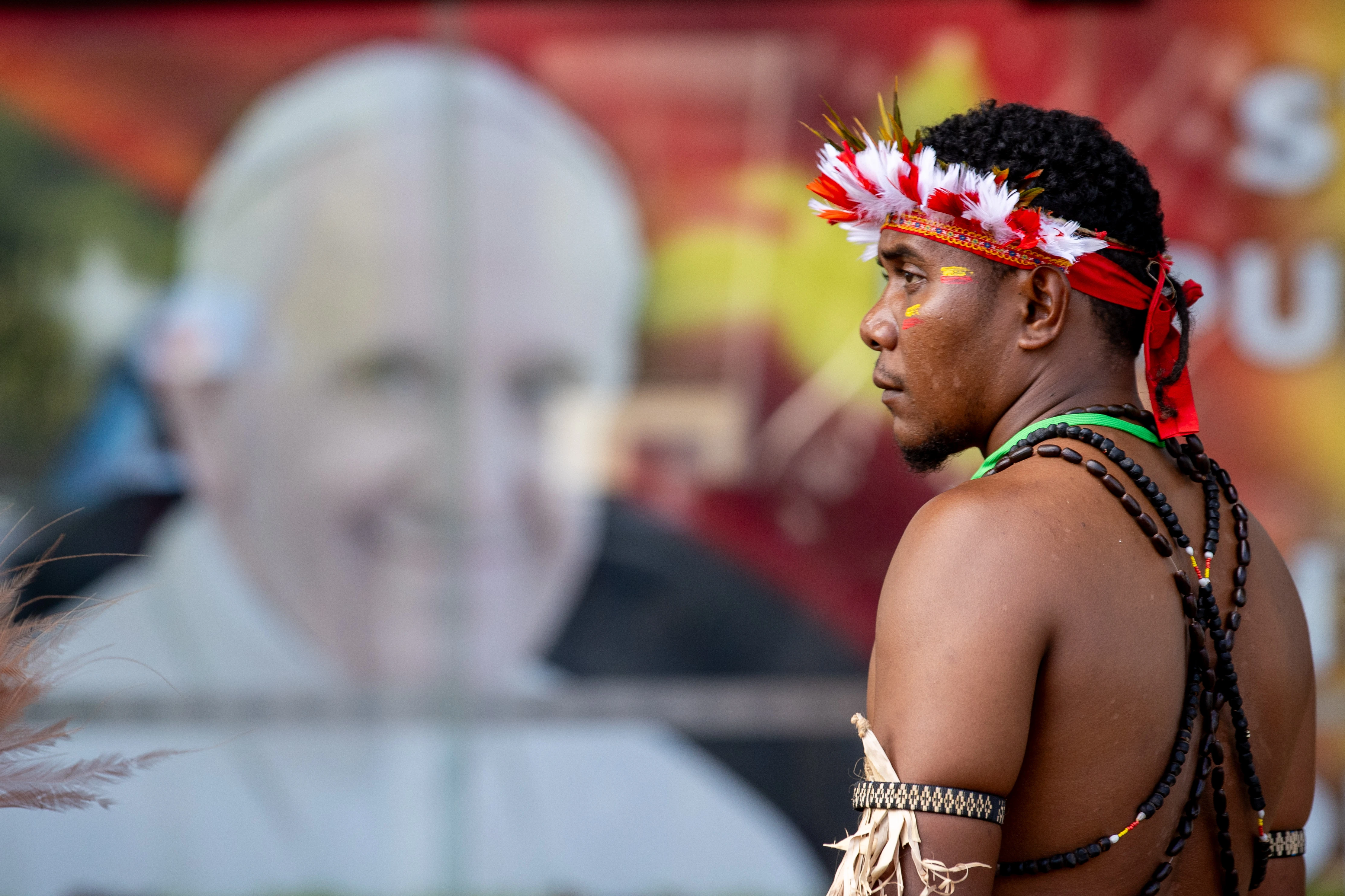 A man stands in front of a poster of Pope Francis outside APEC Haus in Port Moresby, Papua New Guinea, to welcome the Roman pontiff, Sept. 7, 2024.?w=200&h=150