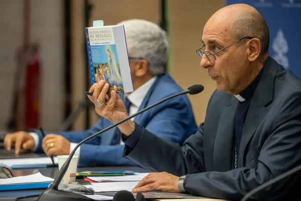 Cardinal Víctor Manuel Fernández, prefect of the Dicastery for the Doctrine of the Faith, holds aloft the book "Medjugorje: The Complete Collection of Messages from the Queen of Peace" at a press conference on Medjugorje in Rome, Thursday, Sept. 19, 2024. Credit: Daniel Ibáñez/CNA