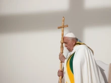 Pope Francis prays during Mass at King Baudouin Stadium in Brussels, Belgium, Sunday, Sept. 29, 2024