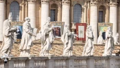 Statuary sits before imagery of the recently canonized saints in St. Peter's Square at the Vatican, Sunday, Oct. 20, 2024