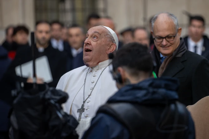 Pope Francis looks up at the statue of the Immaculate Conception