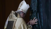 Cardinal Baldassare Reina ceremonially pushes open the Holy Door at St. John Lateran on Dec. 29, 2024.